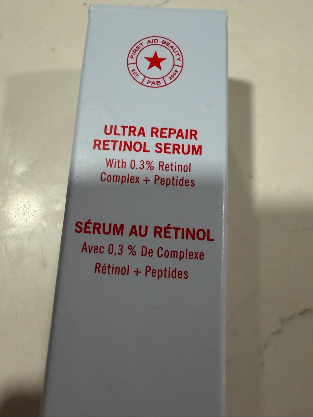 First Aid Beauty Ultra Repair Retinol Serum — White and Red Packaging Accent